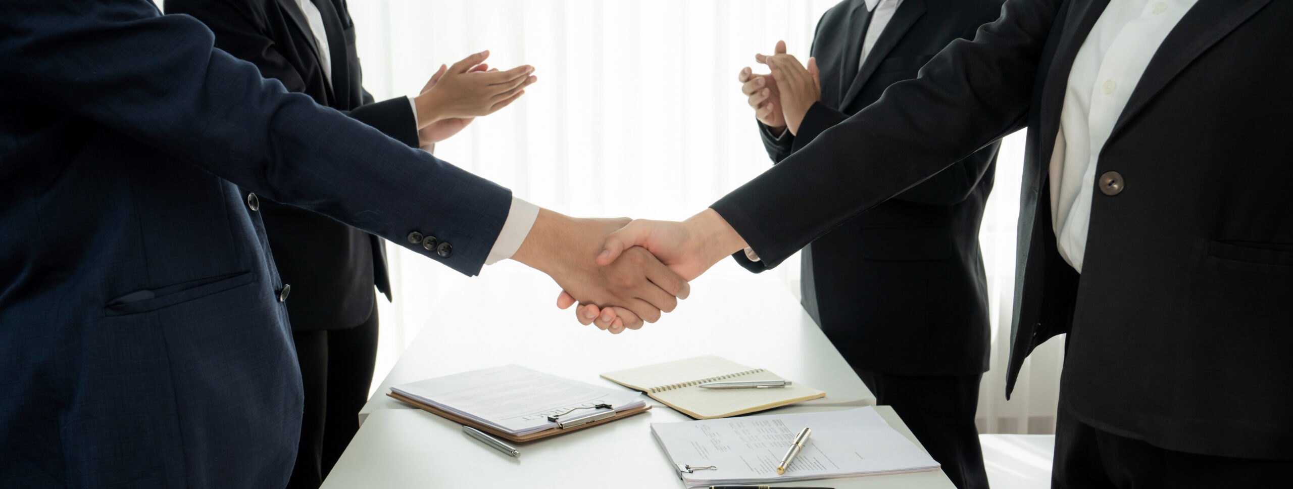 Two business executive shake hand in boardroom for merger and acquisition. Shrewd