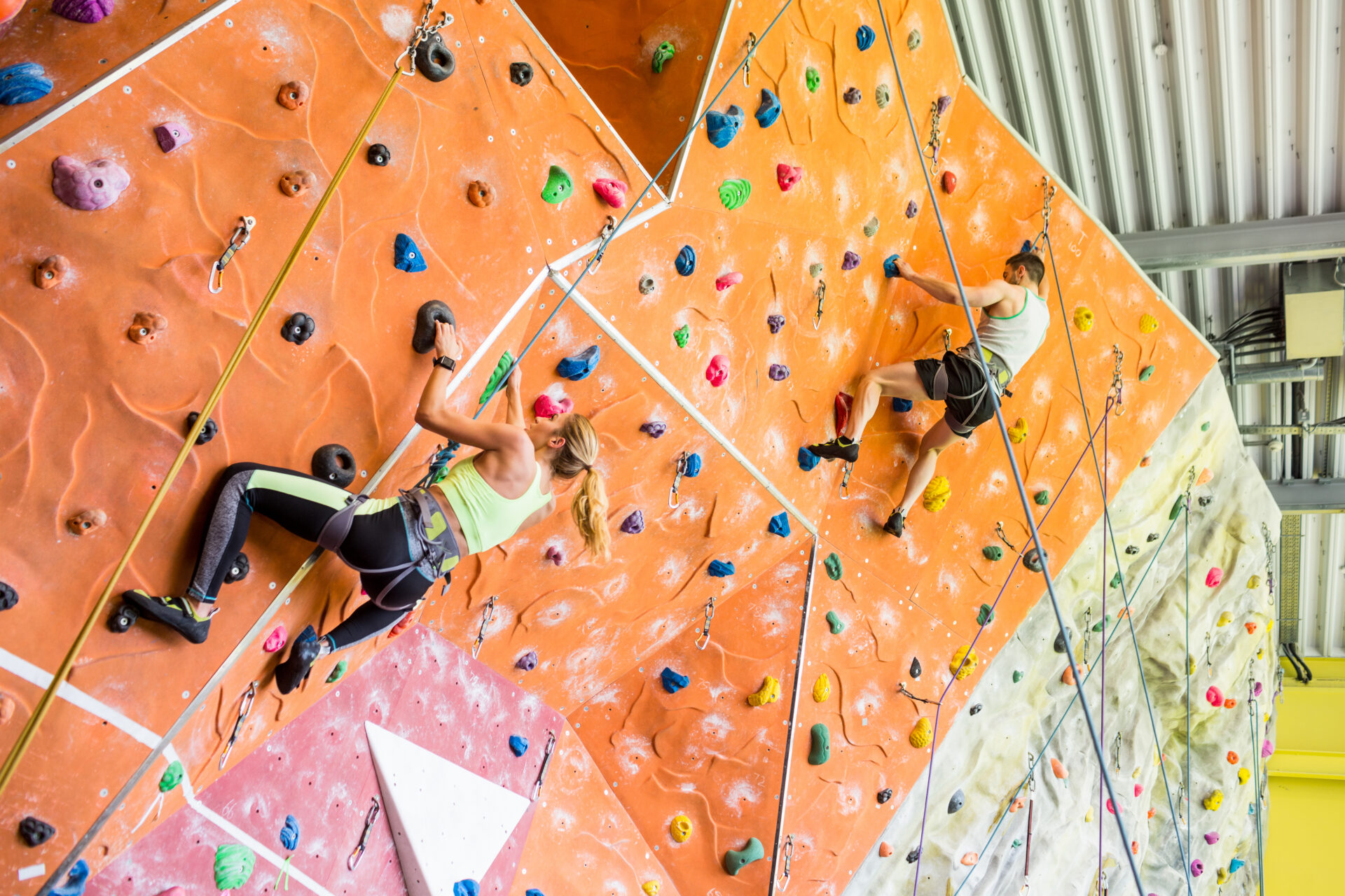 Fit,Couple,Rock,Climbing,Indoors,At,The,Gym